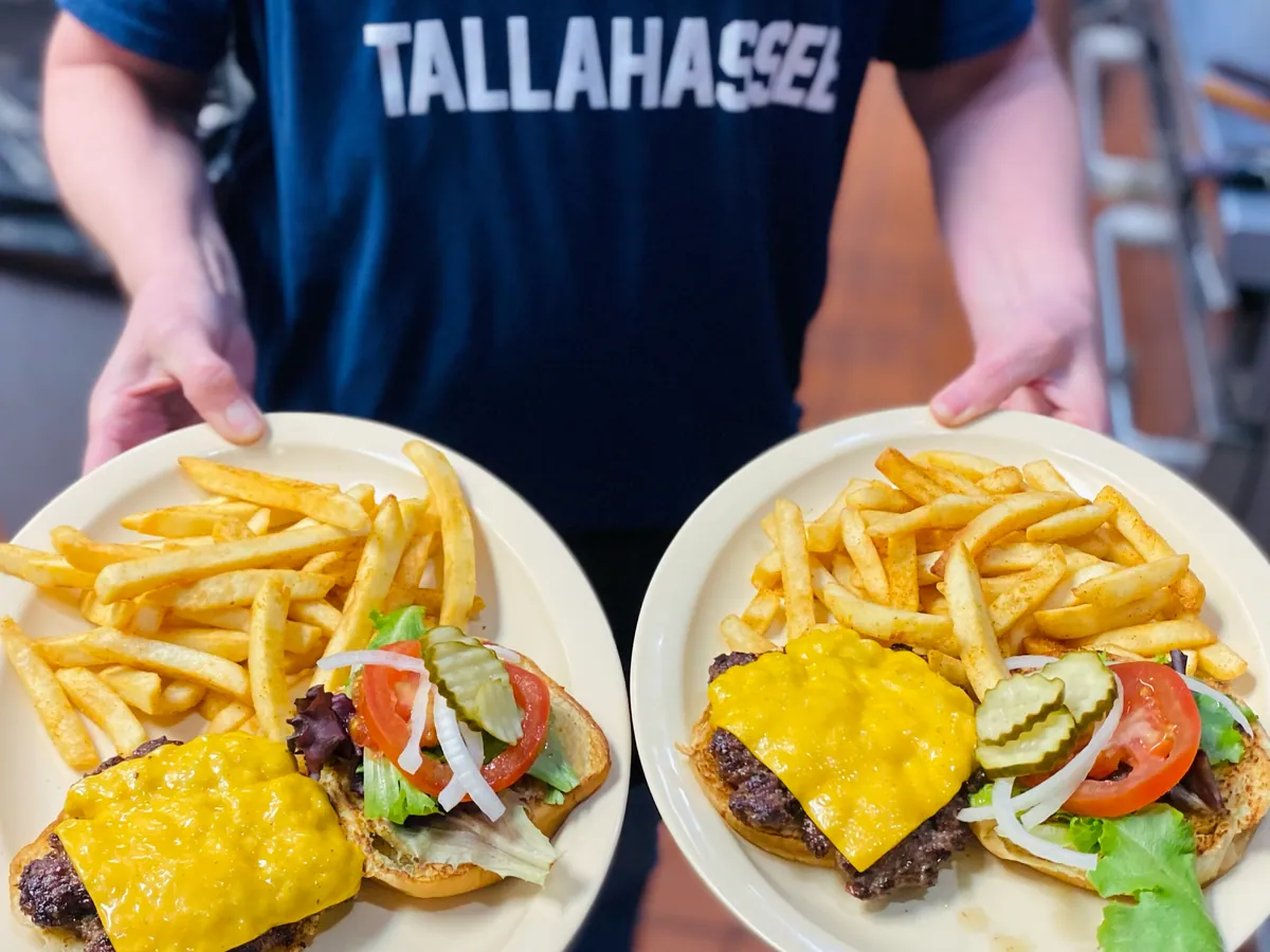 Two burger plates carried out to the counter