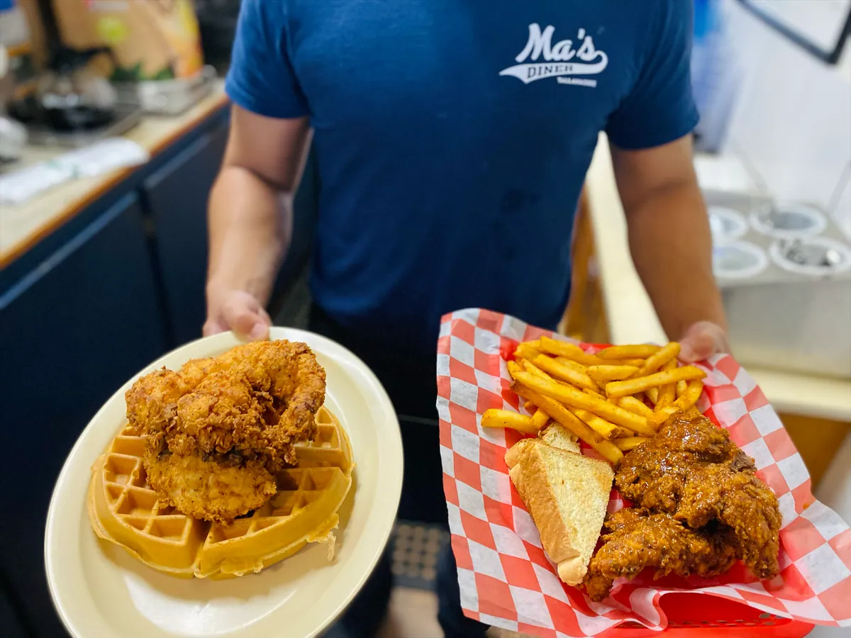 Chicken and waffle, with a basket of fried chicken alongside