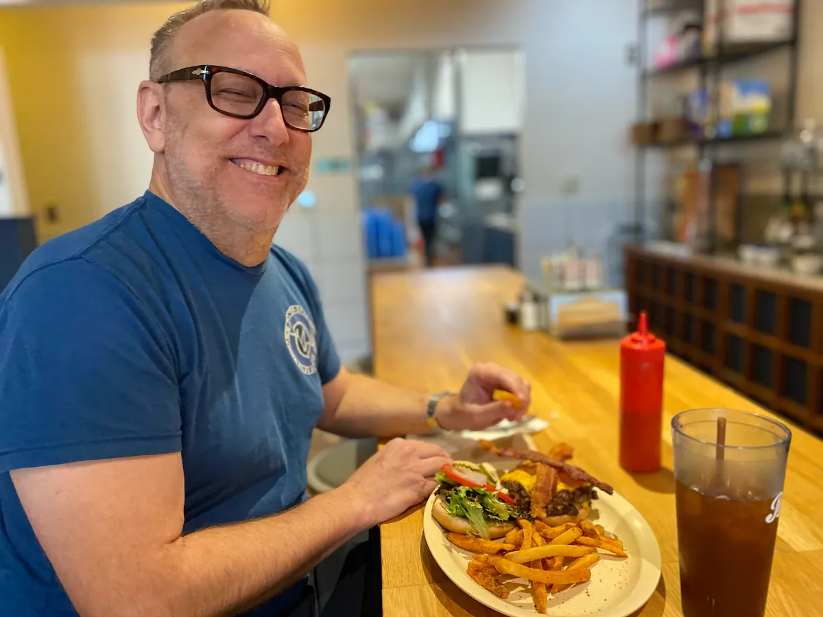 A regular at the counter with a burger